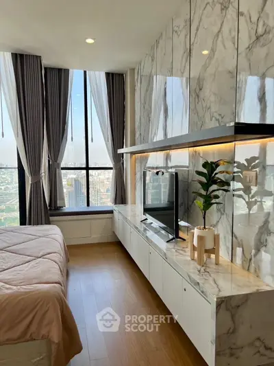 Luxurious bedroom with marble accents and panoramic city view