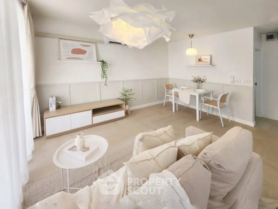 Elegant living room with cozy beige sofa and modern dining area, perfect for relaxation and entertaining.