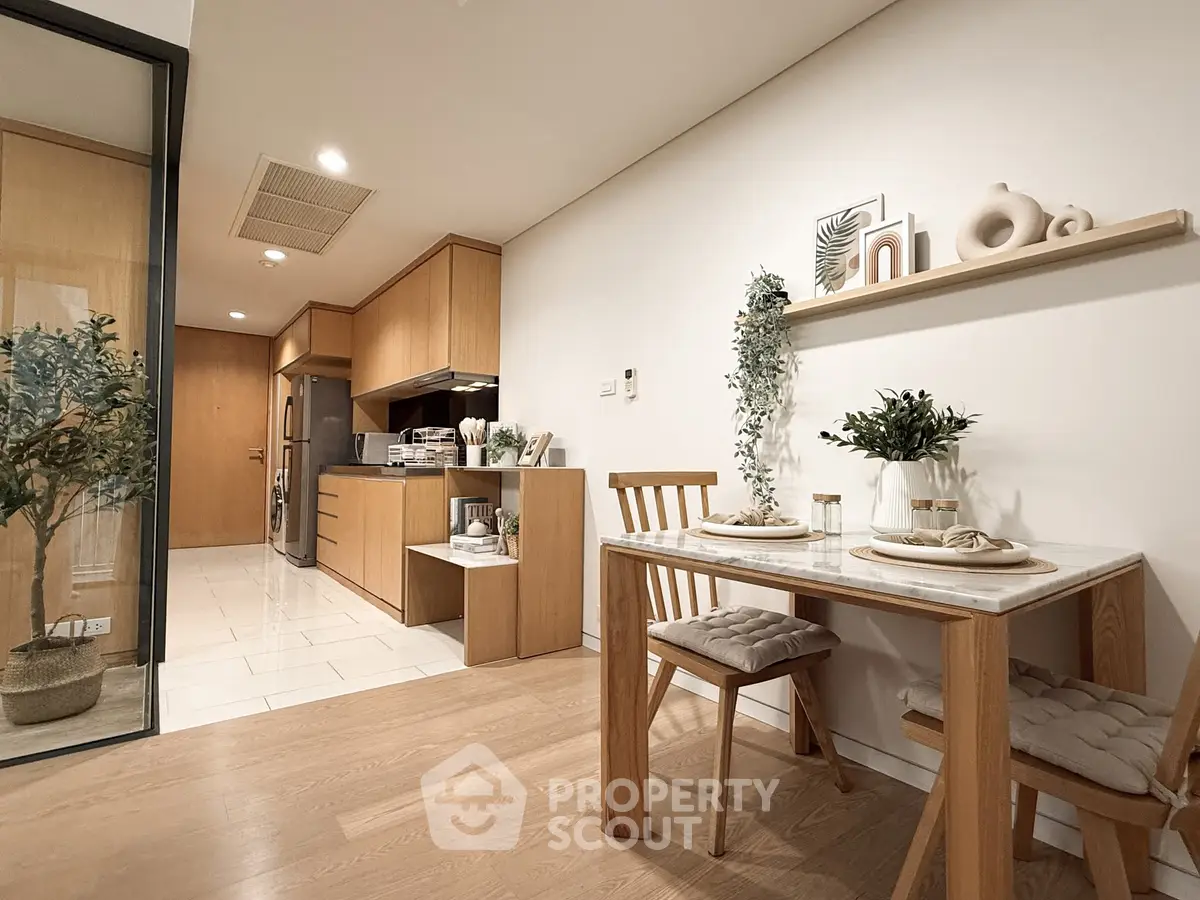 Modern dining area with wooden furniture and open kitchen layout in a stylish apartment.