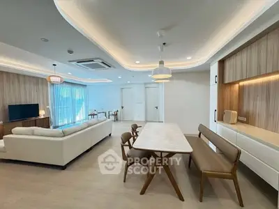 Spacious modern living room with elegant dining area and stylish furniture.