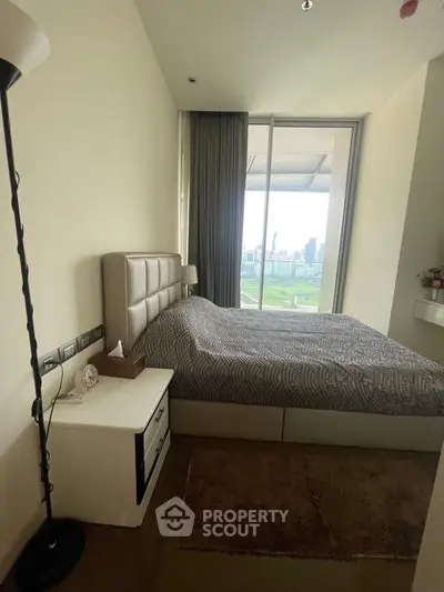 Modern bedroom with city view and stylish decor in high-rise apartment