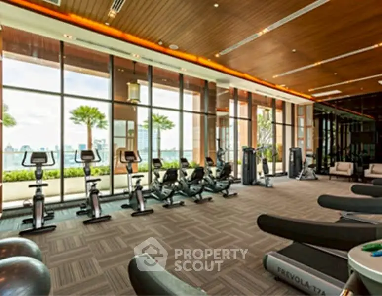 Luxurious gym with panoramic city views and modern fitness equipment in a high-end residential building.