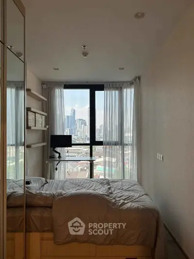 Cozy bedroom with city view, modern decor, and ample natural light.