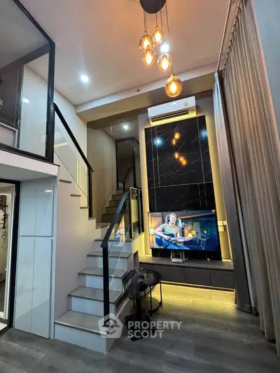 Modern duplex living room with stylish staircase and ambient lighting