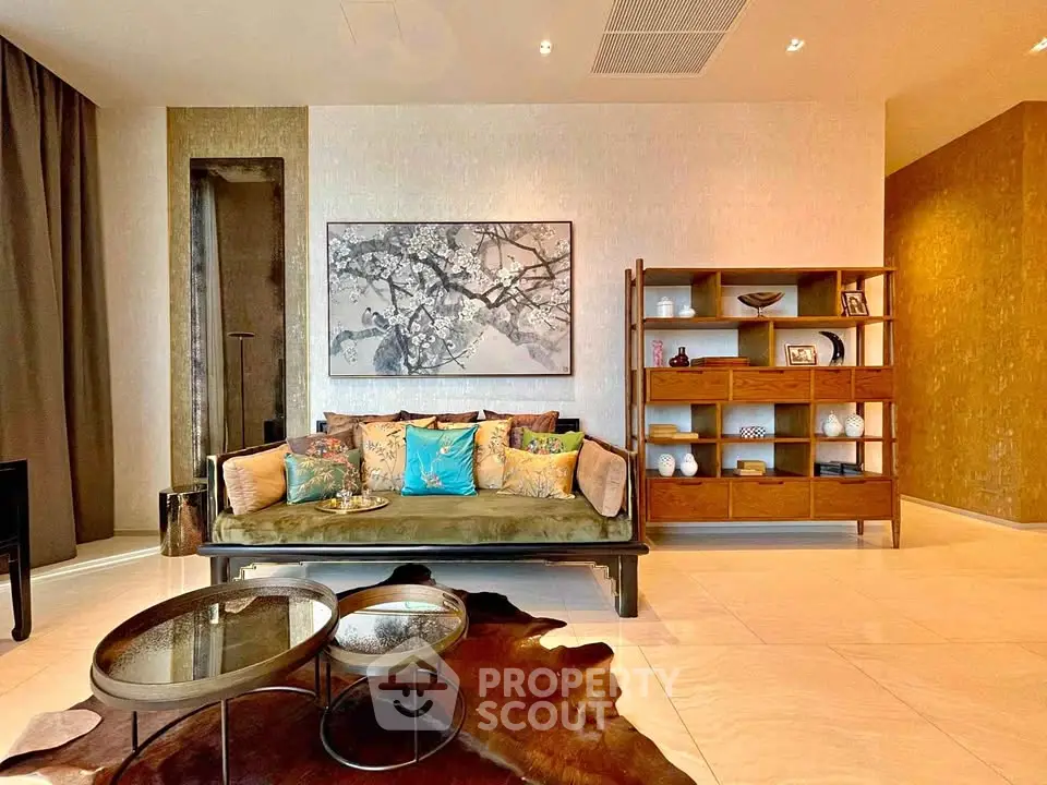 Luxurious living room with elegant decor and stylish furniture, featuring a cozy sofa and modern shelving unit.