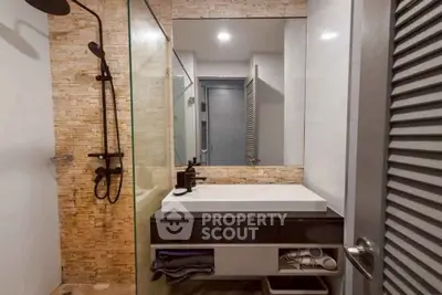 Modern bathroom with sleek fixtures and stone accent wall