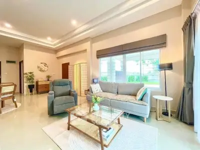 Spacious and bright living room with modern decor and large window view.