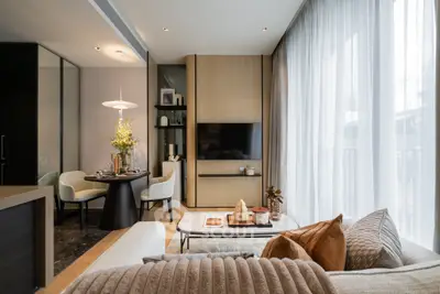 Luxurious modern living room with elegant dining area and floor-to-ceiling windows.