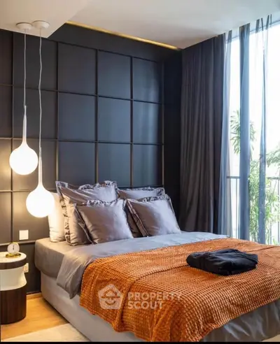 Luxurious modern bedroom with elegant lighting and floor-to-ceiling windows.