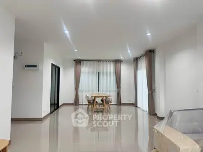 Spacious modern living room with elegant dining area and large windows