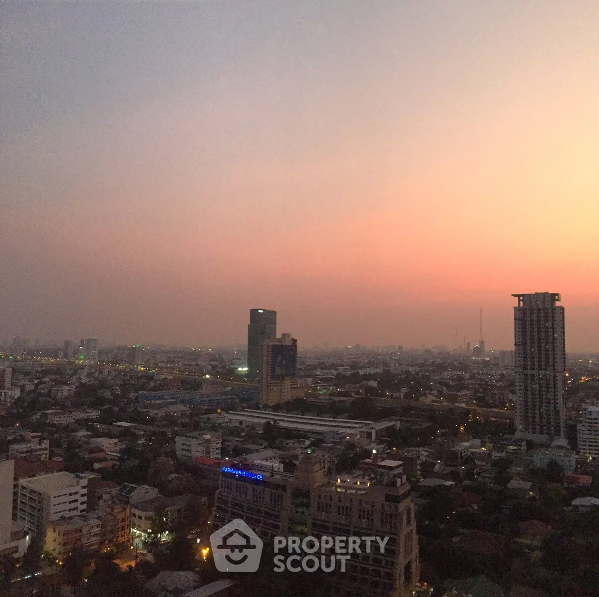 Stunning cityscape view at sunset with high-rise buildings and vibrant skyline.