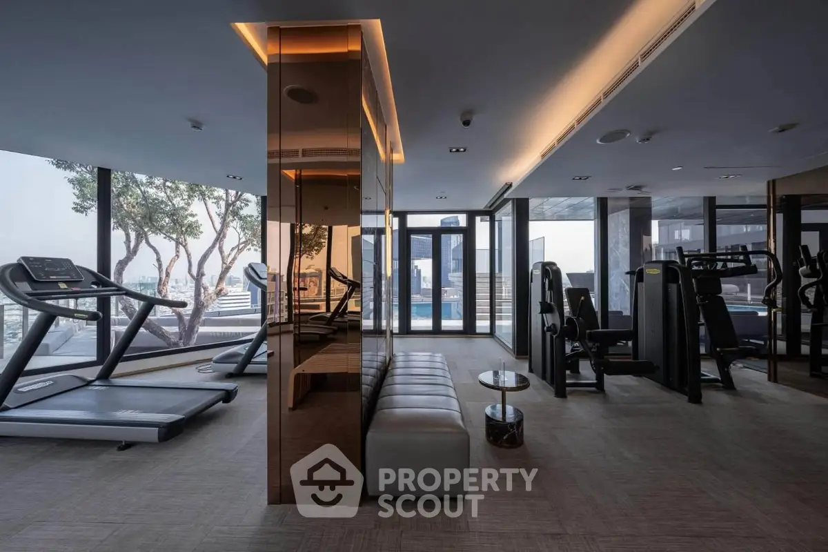 Luxurious high-rise gym with panoramic city views and modern fitness equipment.
