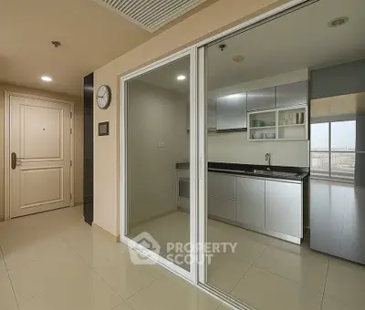 Modern apartment with sleek kitchen and sliding glass doors