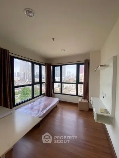 Spacious corner unit bedroom with large windows offering stunning city views.