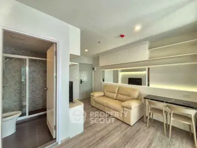 Modern studio apartment with open living area and stylish bathroom
