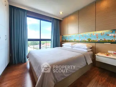 Spacious bedroom with large window and modern decor, offering a serene view and ample natural light.