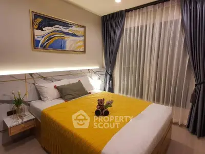 Cozy bedroom with modern decor, featuring a plush bed, elegant curtains, and stylish artwork.