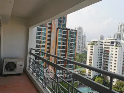 Spacious balcony with stunning cityscape view in modern high-rise apartment.