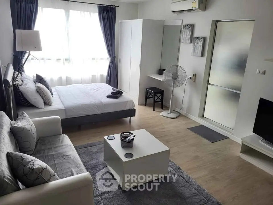 Modern studio apartment with cozy furnishings and natural light