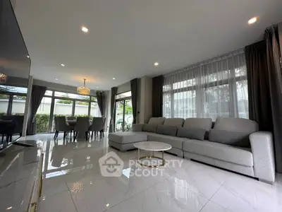 Spacious modern living room with elegant decor and large windows for natural light.