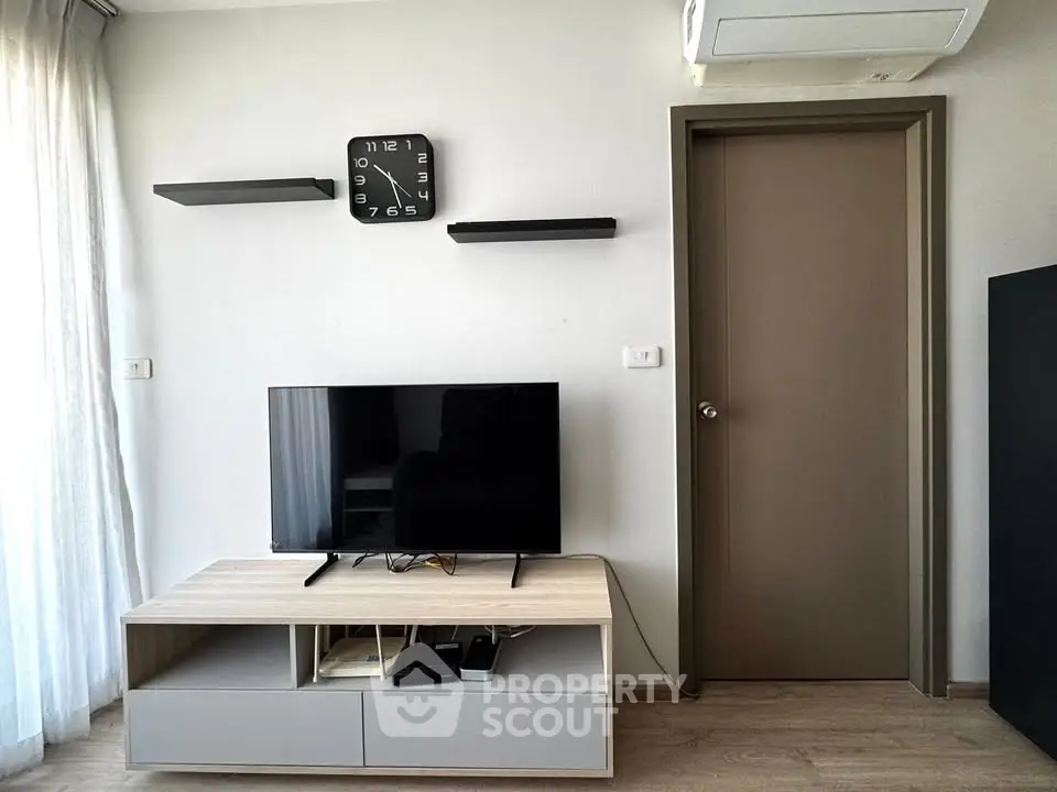Modern living room with sleek TV setup and wall-mounted shelves, perfect for contemporary urban living.