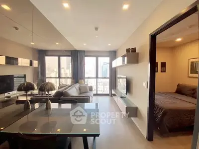 Modern living room with open layout and city view, adjacent to cozy bedroom.