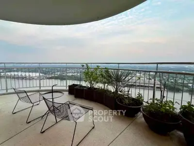 Spacious balcony with stunning river view and modern outdoor seating