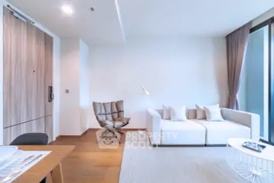 Modern living room with stylish furniture and natural light, featuring a cozy sofa and elegant decor.