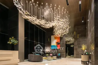 Luxurious modern living room with stunning chandelier and contemporary art