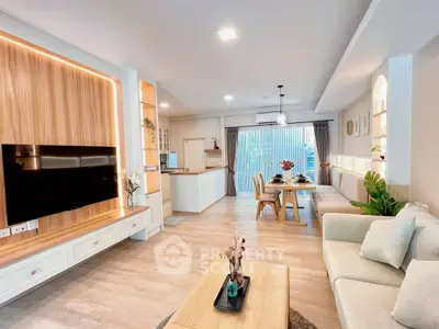 Modern open-plan living room with stylish decor and natural light