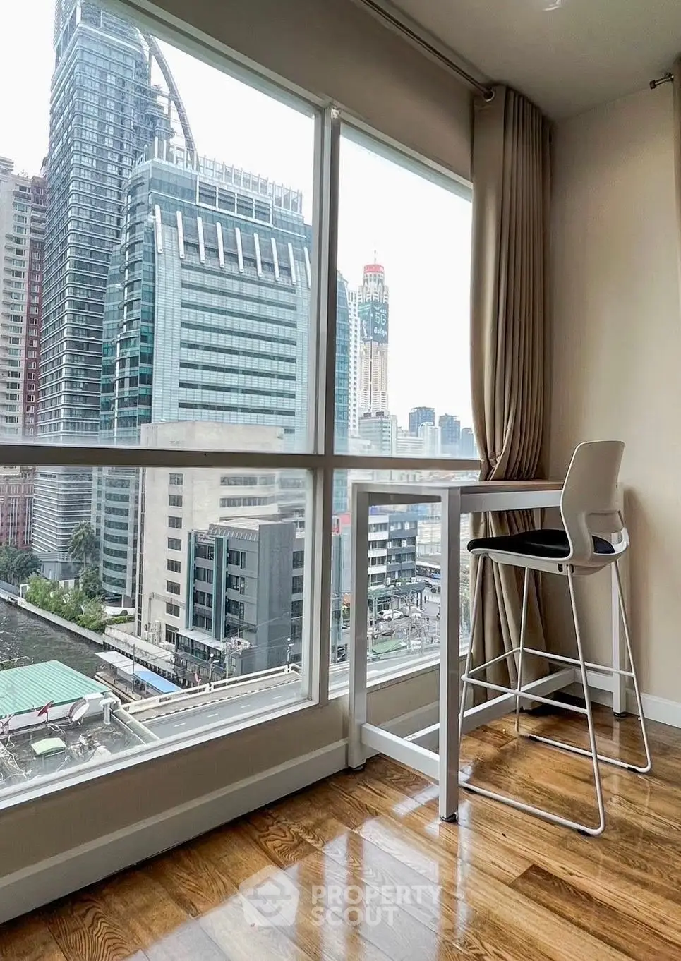 Modern high-rise apartment with stunning city view and sleek interior design.