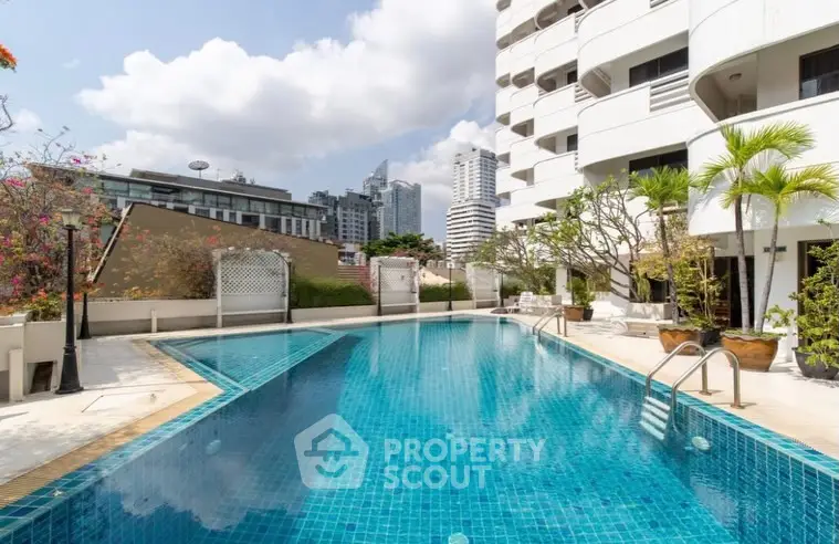 Luxurious rooftop pool with stunning city views in modern apartment complex.