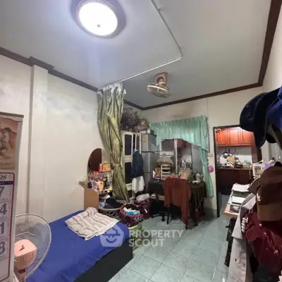 Cozy bedroom with attached kitchen, featuring ample storage and natural light.