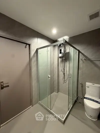 Modern bathroom with glass shower enclosure and sleek fixtures