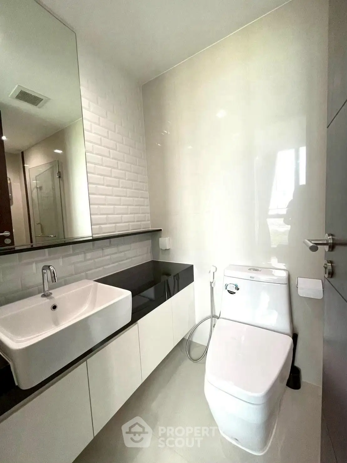 Modern bathroom with sleek fixtures and large mirror