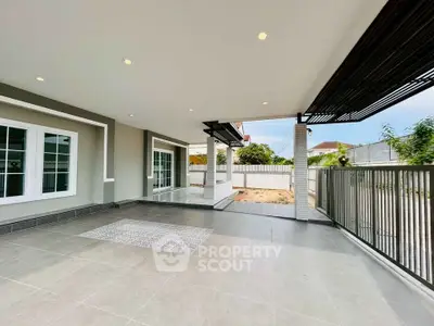 Spacious modern patio with elegant design and ample natural light, perfect for outdoor relaxation.