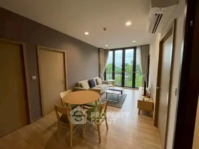 Modern living room with stylish furniture and large windows offering a scenic view.