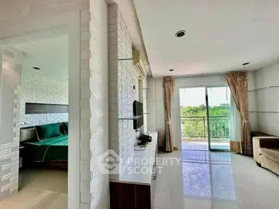 Modern living room with balcony and bedroom view, featuring sleek design and natural light.