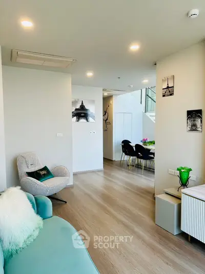 Modern living room with stylish decor and open dining area