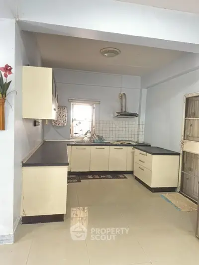Spacious kitchen with modern cabinetry and ample natural light