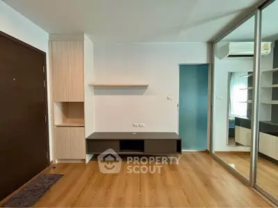 Modern living room with wooden flooring and built-in storage solutions