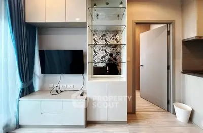 Modern living room with TV, stylish shelving, and elegant decor
