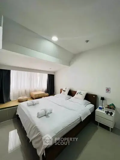 Modern bedroom with cozy bed and natural light in stylish apartment