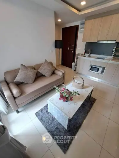 Modern living room with cozy sofa and stylish kitchen in open layout apartment