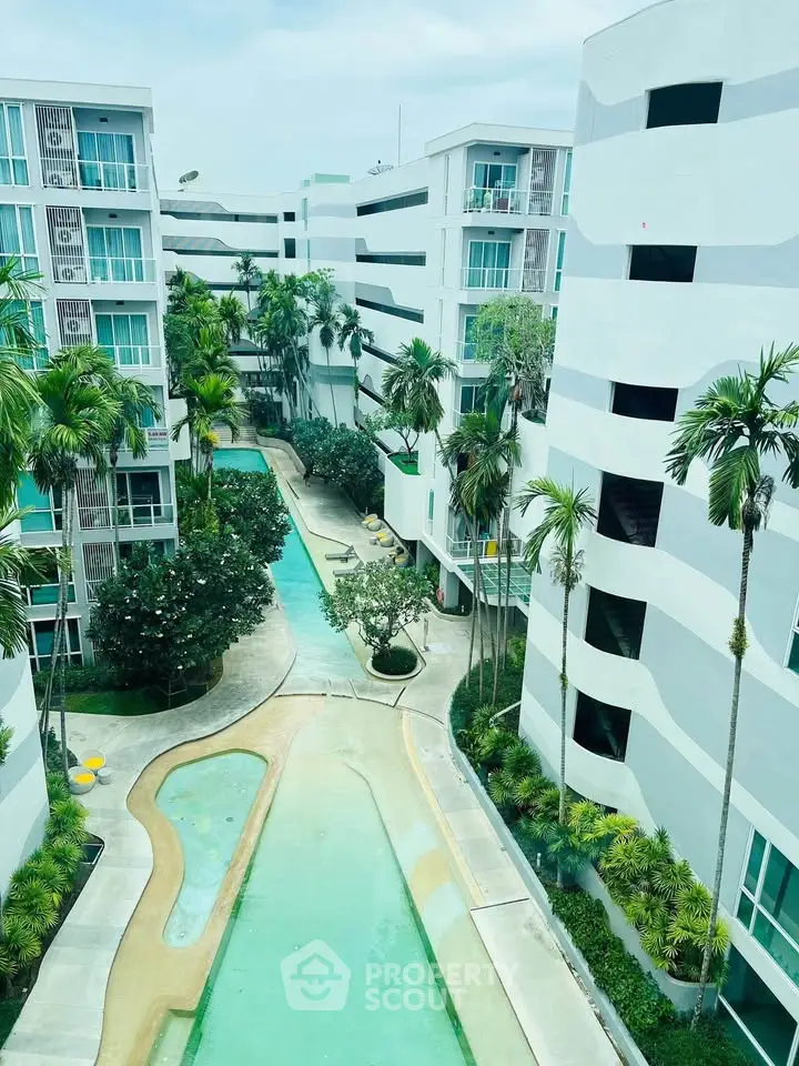 Modern apartment complex with lush landscaping and pool view