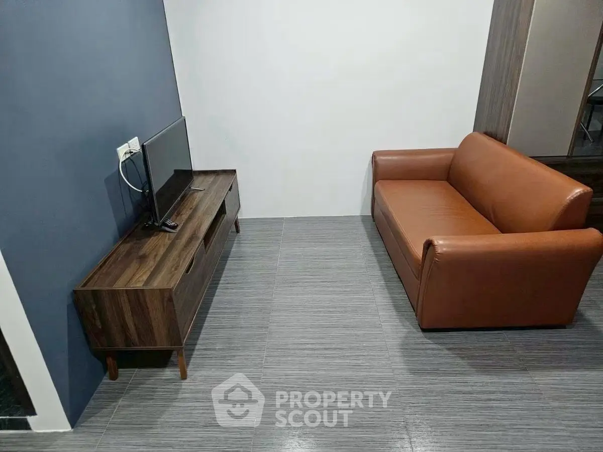 Modern minimalist living room with sleek brown sofa and wooden TV stand.