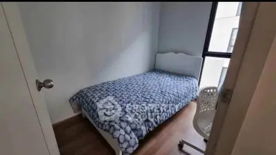 Cozy bedroom with single bed and modern decor in bright apartment.