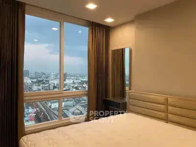 Modern bedroom with large window offering stunning city view