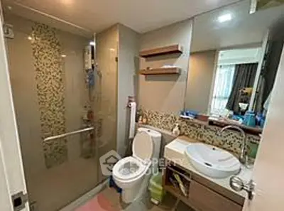 Modern bathroom with glass shower and stylish vanity in a contemporary apartment.