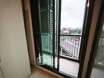Modern apartment balcony with city view and sliding glass doors